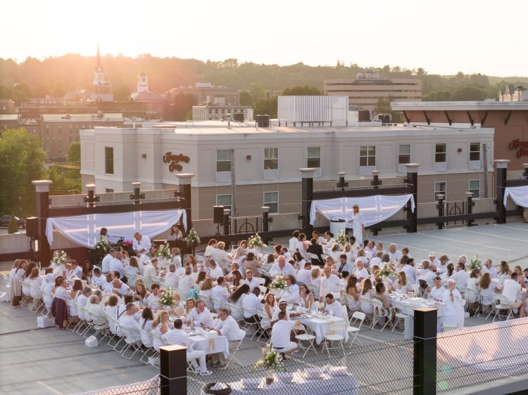 Attendees of the 2023 Soirée en Blanc dined and celebrated on the roof of the Lincoln Street garage. This year, the party will be at the former Peck's department store with a snowy, winter theme.